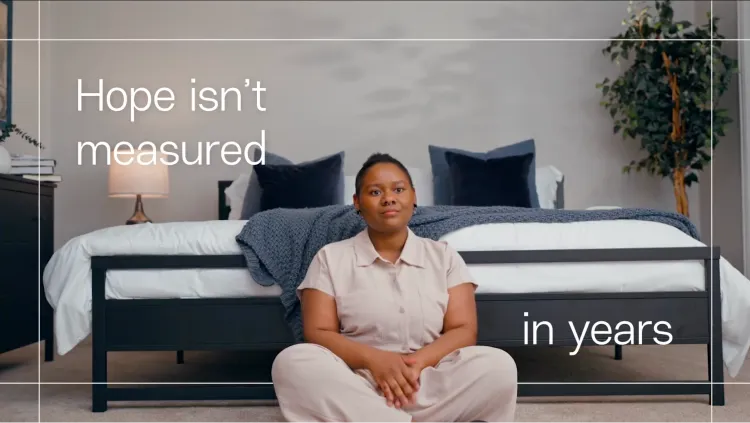 Cierra sits before her bed as the text reads ‘Hope isn’t measured in years.’