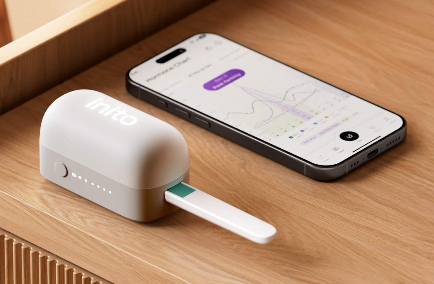 The full Inito system showing InSight Wireless Reader™ with the test strip inserted and Inito app on its side